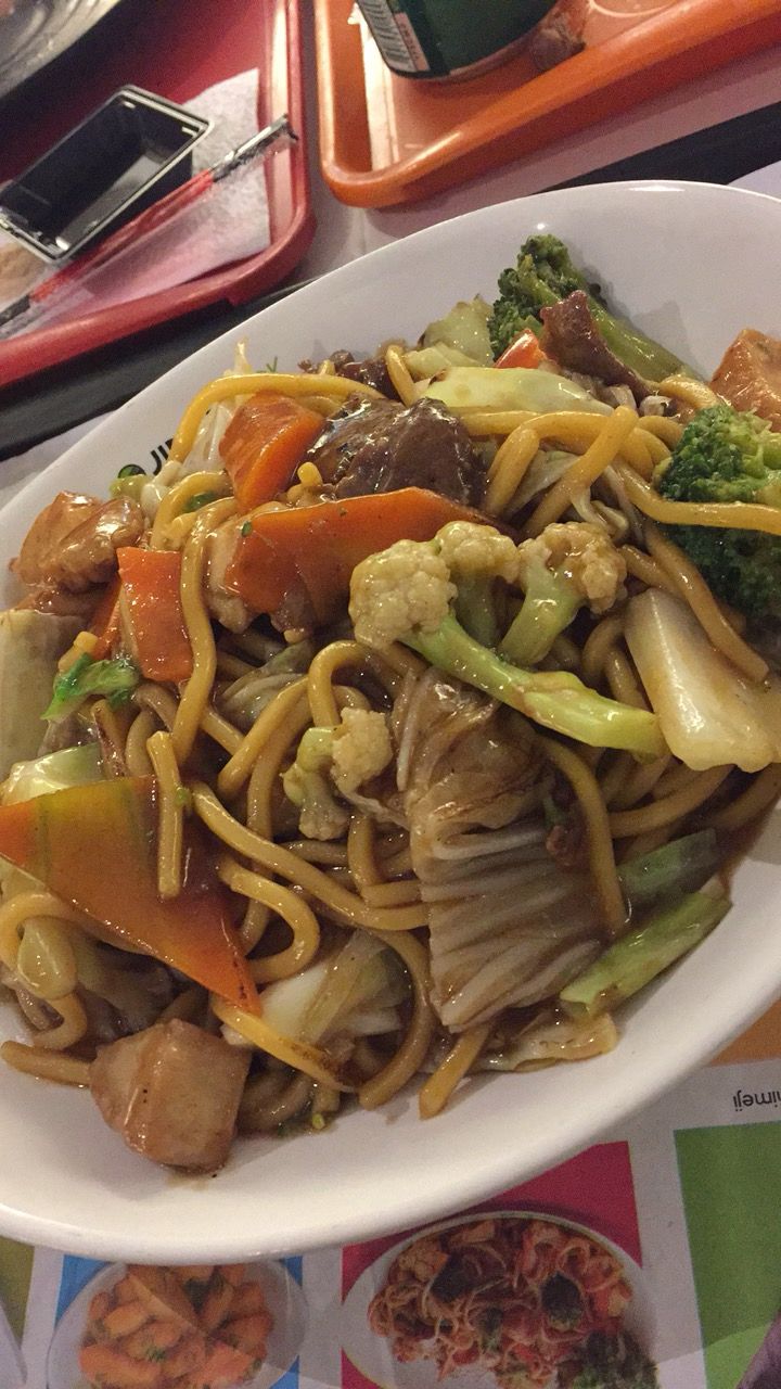 a white plate topped with noodles and vegetables