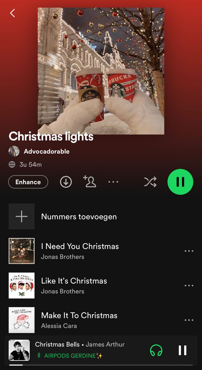 the christmas lights app on an iphone with music player and other items in front of it