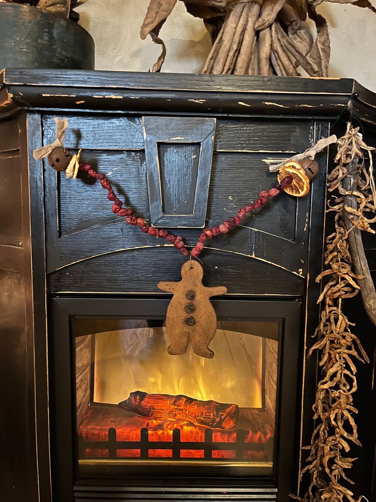 a fireplace with a christmas decoration hanging from it's side