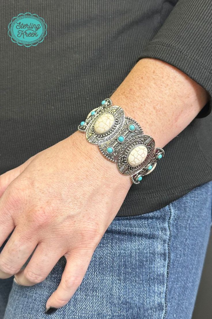 This one-of-a-kind silver bracelet is a real gem! Featuring unique turquoise and white stones, it's sure to add a sparkle to any outfit. So slip it on and show the world your fashionable flair!  width: 1.25  Dont forget to add the matching necklace and earrings! (sold separately)