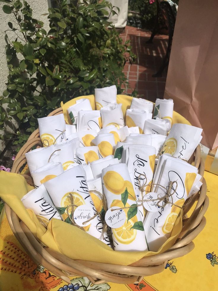 a basket filled with lots of lemons on top of a yellow cloth covered table