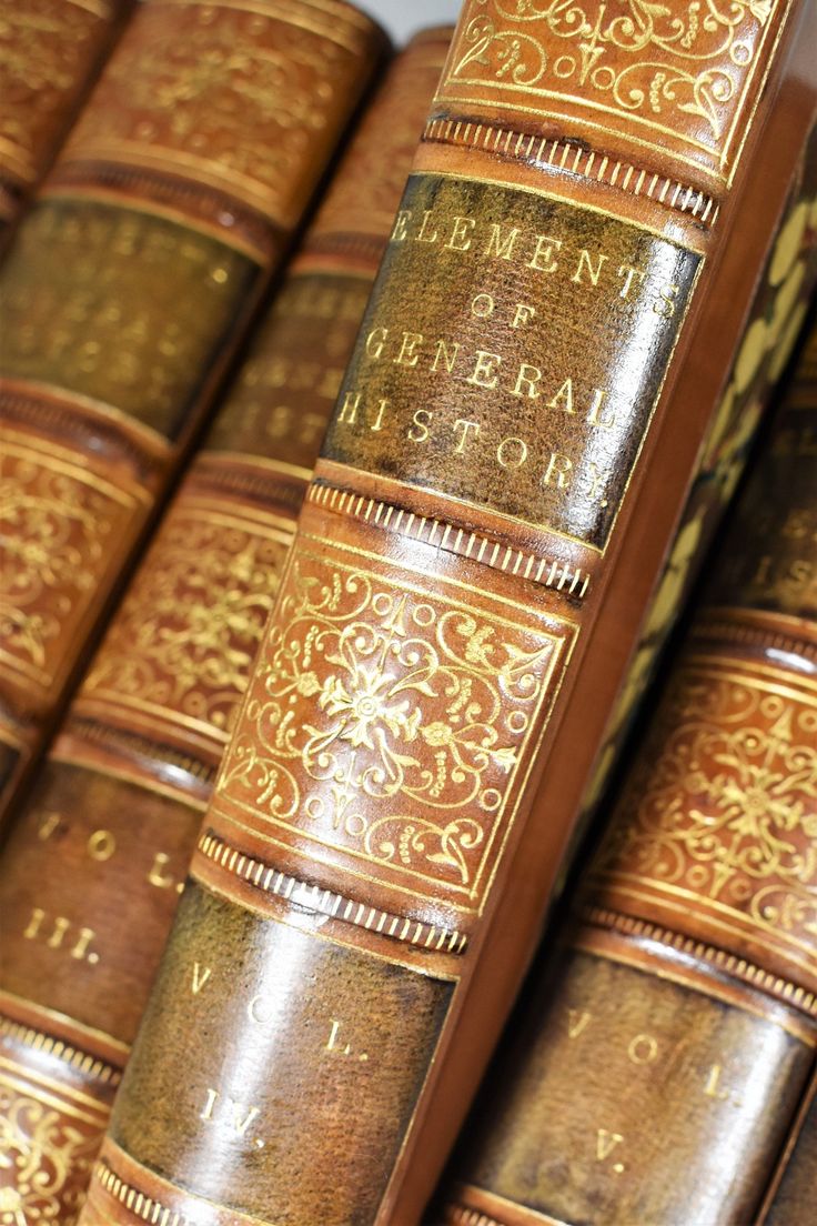 an old book is sitting on top of the bookshelf in front of it