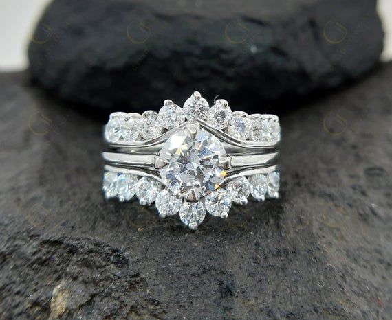 a diamond ring sitting on top of a rock