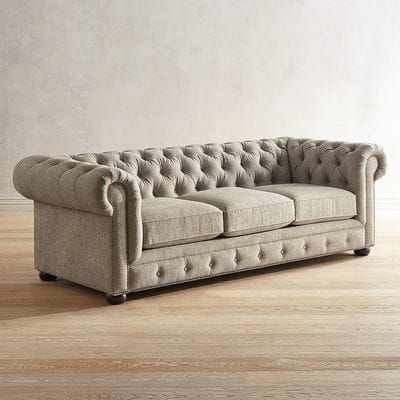 an image of a couch that is in the middle of a room with wood flooring