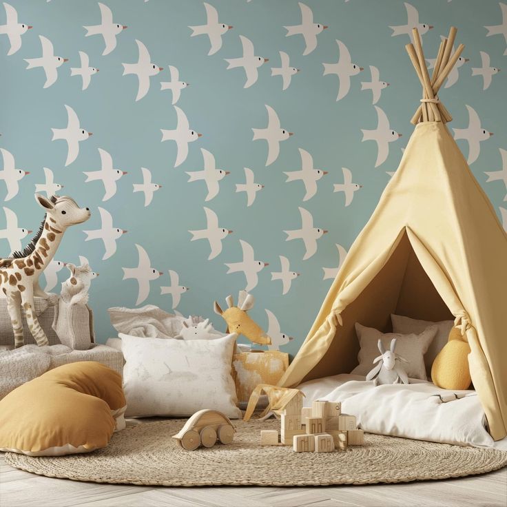 a child's bedroom with a teepee tent, toys and giraffe wallpaper