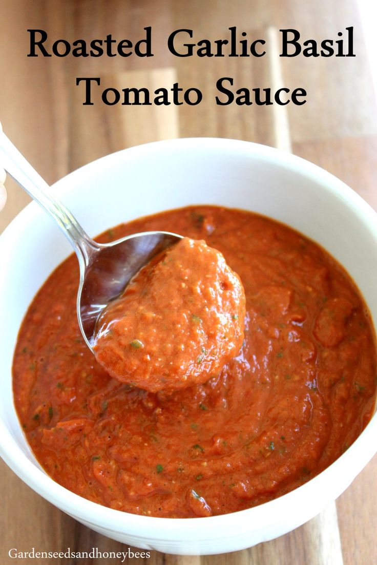 roasted garlic basil tomato sauce in a white bowl with a spoon