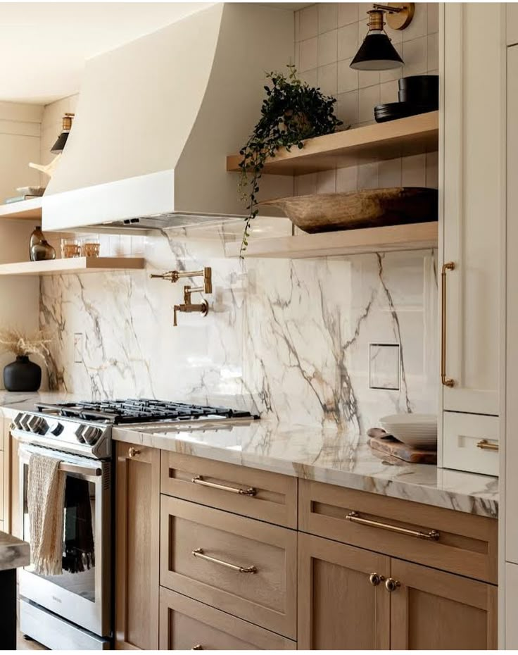 a kitchen with marble counter tops and wooden cabinets, along with open shelving above the stove