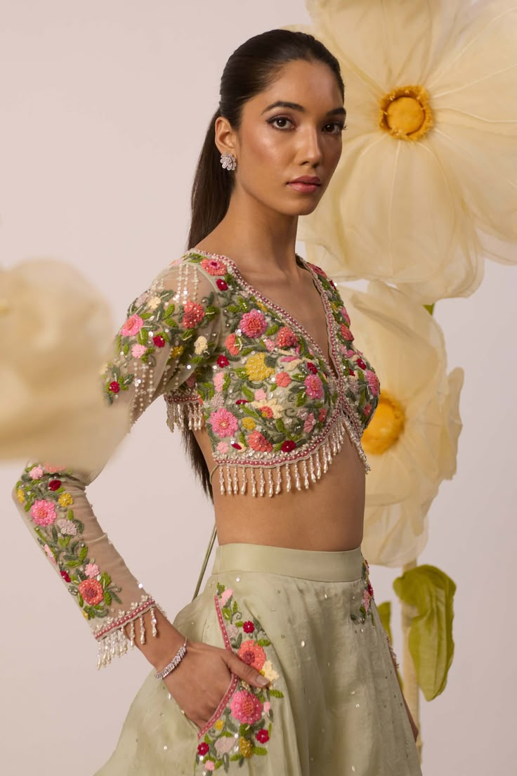 A burst of freshness - that's what this lupin pistachio green lehenga set is all about! Paired with multicolor resham embroidered full sleeves blouse in a monochrome shade, it is the ultimate bridesmaids's dream. The skirt, crafted in organza, features intricate embroidery on circumference part of the lehenga, and is perfect for twirl-ready moments. Also featuring a organza dupatta with the same to go all out with it Green Zari Work Party Wear Blouse, Green Zari Work Blouse For Party Wear, Spring Green Sharara With Zari Work, Green Sharara With Zari Work For Spring, Pista Green Saree Set For Spring, Traditional Green Choli For Spring, Festive Green Choli For Spring, Spring Festive Green Choli, Pista Green Choli With Floral Embroidery For Party