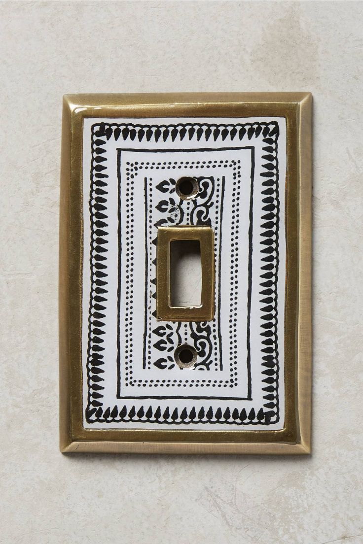 a decorative light switch plate cover in black and white