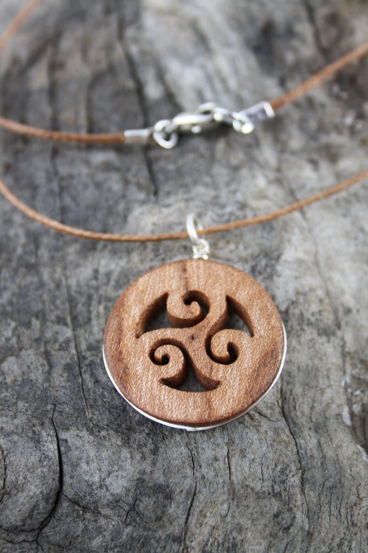 "This beautiful and unique hand-carved Triskelion pendant will be made for you, or a loved one, in my studio on the West of Ireland. Encircled with a Sterling silver ring into a side groove, this intricate carving features a piece of elm. Considered one of the sacred trees in the Celtic world, elm has often been associated with Mother and Earth Goddesses. In rural Ireland the elm tree was said to possess magical properties and was considered to be the home of the fairies. Found inscribed on mega Symbolic Carved Brown Jewelry, Natural Carved Adjustable Jewelry, Natural Color Carved Adjustable Jewelry, Nature-inspired Carved Natural Jewelry, Traditional Spiral Jewelry For Gifts, Nature-inspired Carved Round Pendant Jewelry, Brown Spiral Necklace For Gifts, Brown Spiral Jewelry As A Gift, Rural Ireland