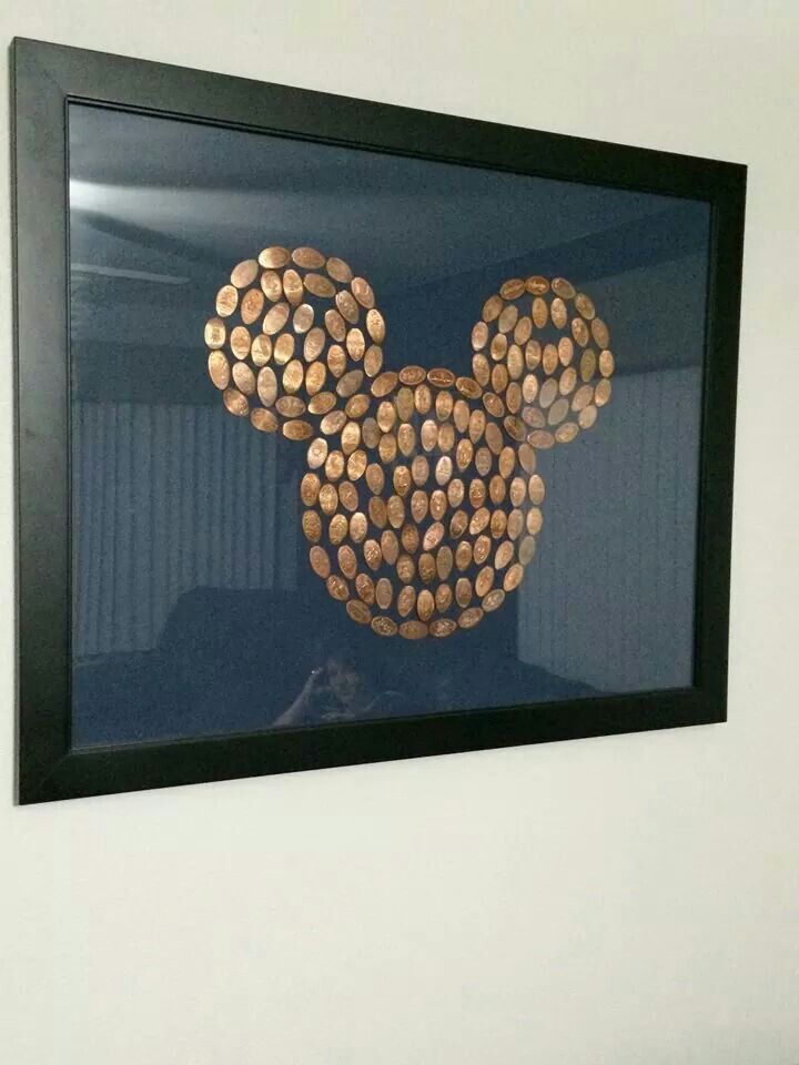 a mickey mouse made out of wine corks hanging on the side of a wall