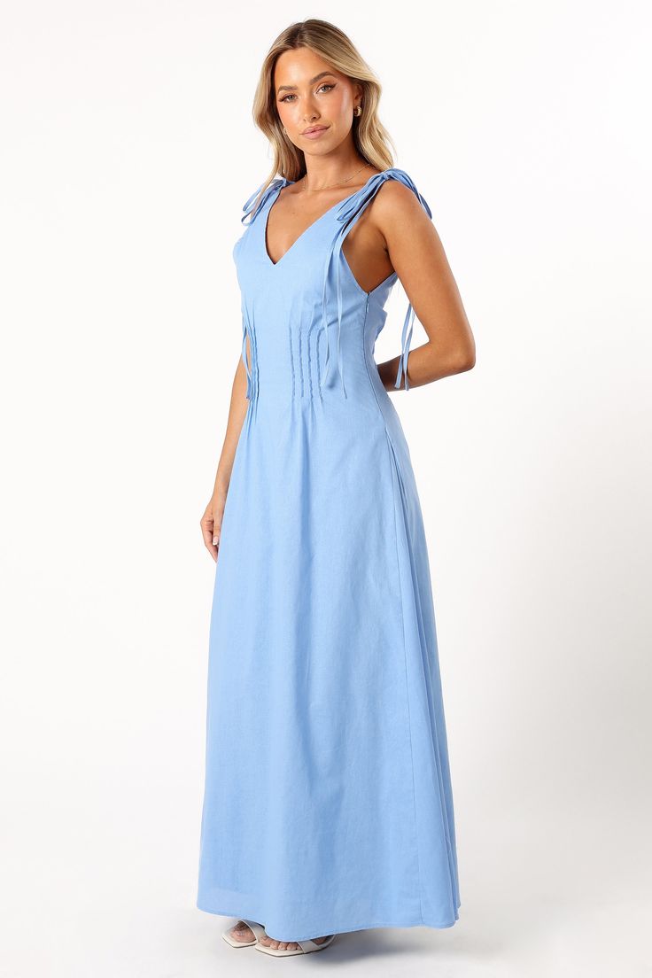 DETAILS  Experience a blend of comfort and style with our Lainey Maxi Dress in Blue. This outfit is defined by its maxi length and a flattering V neckline, complemented by wide straps that close with a double tie for an added touch of elegance. The back mirrors the front with a V design, and the bodice features pleat details for that extra sophistication.  maxi length  v neckline  wide straps with double tie close  back v design  pleat detail on bodice  side invisible zip with hook and eye clasp V-neck Dress With Knotted Straps For Day Out, Chic V-neck Maxi Dress With Knotted Straps, Fitted Maxi Dress With Tie Straps For Day Out, Fitted Maxi Dress With Knotted Straps For Day Out, Chic Spaghetti Strap Maxi Dress With Tie Waist, Chic Maxi Dress With Spaghetti Straps And Tie Waist, Spring Blue Maxi Dress With Tie Waist, Sleeveless Maxi Dress With Tie Fastening For Day Out, Summer V-neck Maxi Dress With Tie Fastening