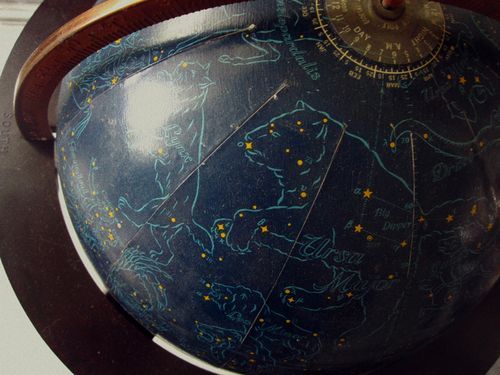 a blue and gold globe with stars on it