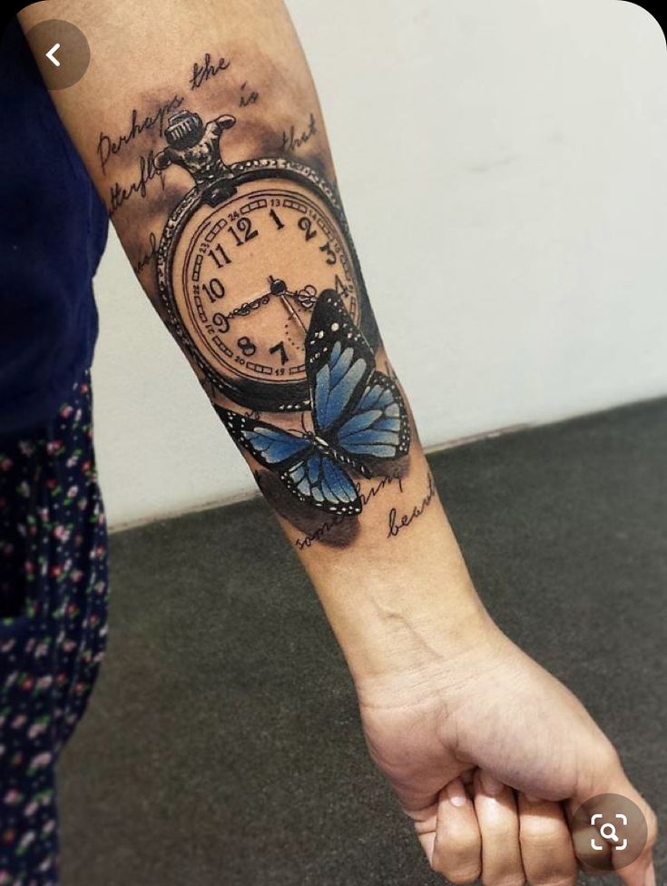 a person with a butterfly tattoo on their arm holding an alarm clock in one hand