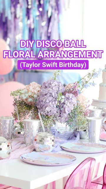 a white table topped with lots of pink and purple flowers