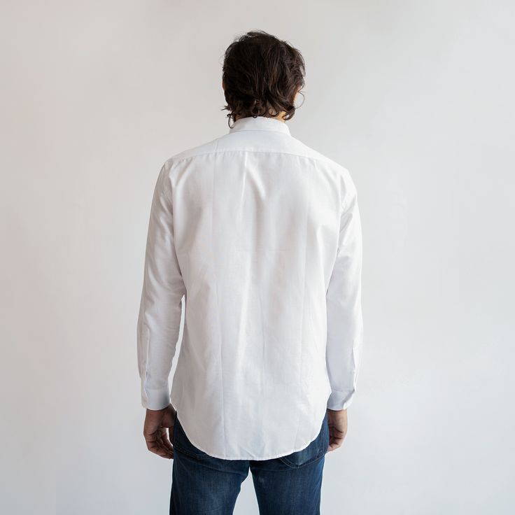 The White Oxford shirt is one of the most timeless and versatile pieces in the service industry, able to be dressed up with a blazer, or down with jeans and sneakers. The updated and upgraded version of our Service Oxford features an equally durable but much softer 75/25 cotton poly blend, as well as cleaner stitching, a crisper collar, and an improved fit. Features: Button-down collar, clean finished seams Material: 75% Cotton, 25% Polyester, 4oz White Oxford Cloth Fit: Model is 6'0"/170 lbs, w Tailored Cotton Dress Shirt For Spring, Tailored Cotton Dress Shirt With Button Cuffs, Spring Cotton Tailored Dress Shirt, Spring Tailored Cotton Dress Shirt, Modern Tailored Cotton Shirt, Classic Dress Shirt With Relaxed Fit For Everyday, Classic Fitted Everyday Shirt, Classic Relaxed Fit Dress Shirt For Everyday, Business Cotton Shirt With Relaxed Fit