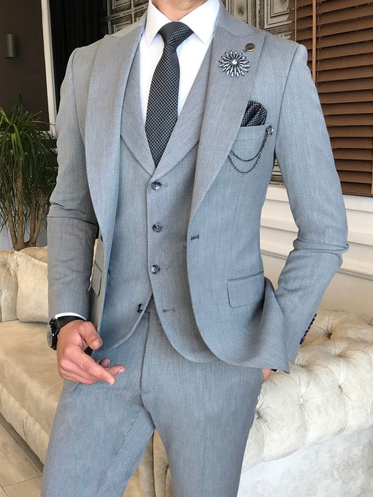 Color: Grey Material: 65% Polyester, 32% viscose, 3% lycra Suit includes blazer, waistcoat & trousers Single-breasted (1 button) Lapel type: peak lapels Jacket interior lining option: fully-lined Jacket Vent: Double Vent Fitting: slim-fit Care instructions: dry clean only Machine washable: no