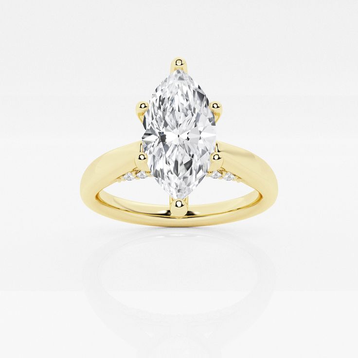 a yellow gold engagement ring with an oval cut diamond in the center and side stones