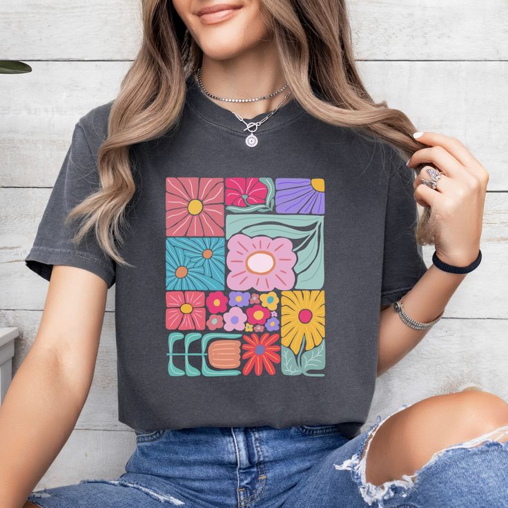 Add a touch of boho to your wardrobe with our Boho Flower T-Shirt. Featuring a beautiful floral design, this shirt will add a unique and playful touch to your style. Embrace your inner flower child and stand out from the crowd with this abstract yet stylish t-shirt. Hippie Multicolor T-shirt For Spring, Bohemian Spring T-shirt With Graphic Print, Spring Hippie Retro Print T-shirt, Casual Short Sleeve Top With Floral Patchwork, Casual Tops With Floral Patchwork For Spring, Casual Multicolor Tops With Floral Patchwork, Casual Multicolor Floral Patchwork Tops, Spring Hippie T-shirt With Screen Print, Hippie T-shirt With Screen Print For Spring