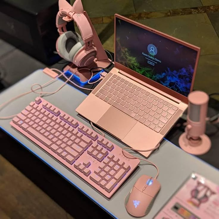 an open laptop computer sitting on top of a desk next to a keyboard and mouse