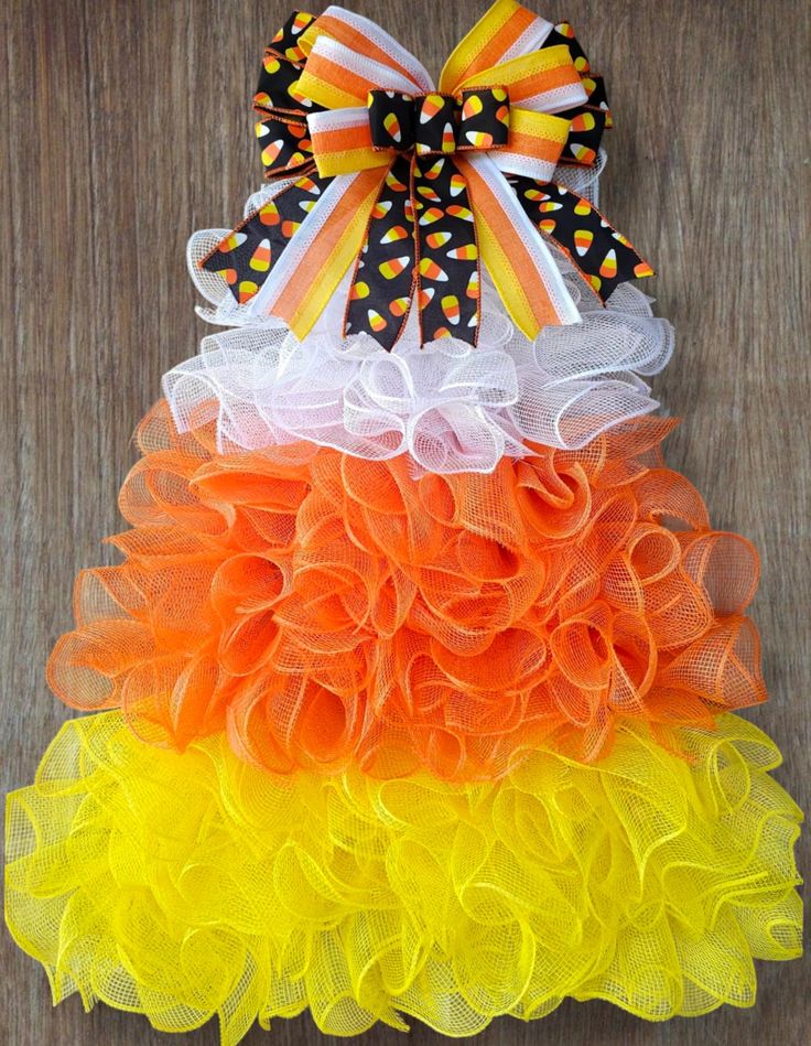 an orange, yellow and white tulle skirt with polka dots on the bottom layer