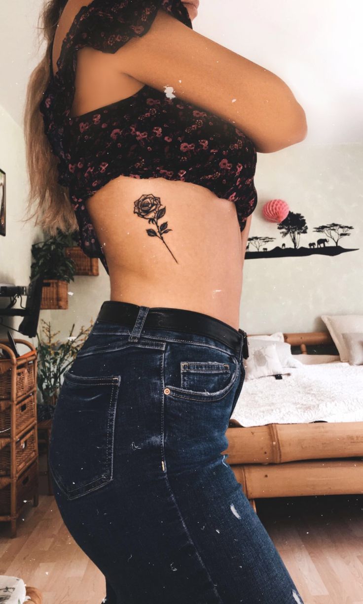 a woman with a rose tattoo on her stomach