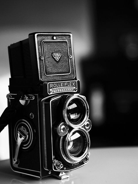 a black and white photo of an old camera with the words life is like a camera