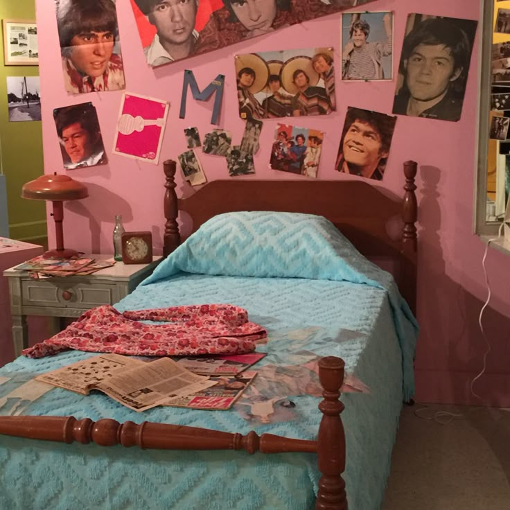 a bed in a room with many pictures on the wall