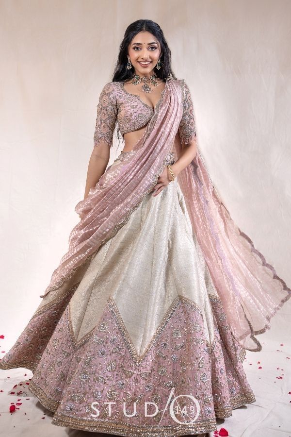 a woman in a pink and white lehenga