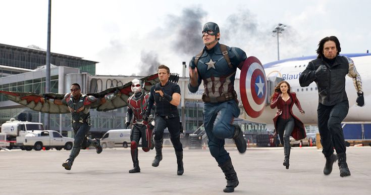 the avengers are running in front of an airplane