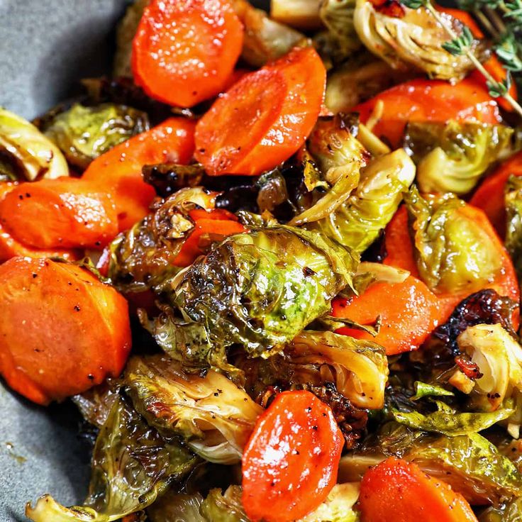 a bowl filled with cooked vegetables on top of a table