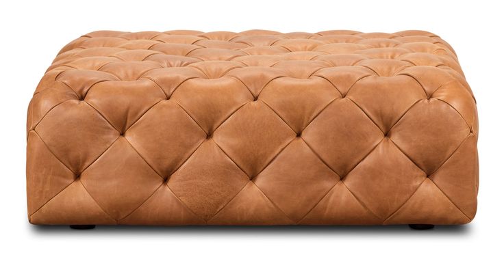 a tan leather foot stool on white background