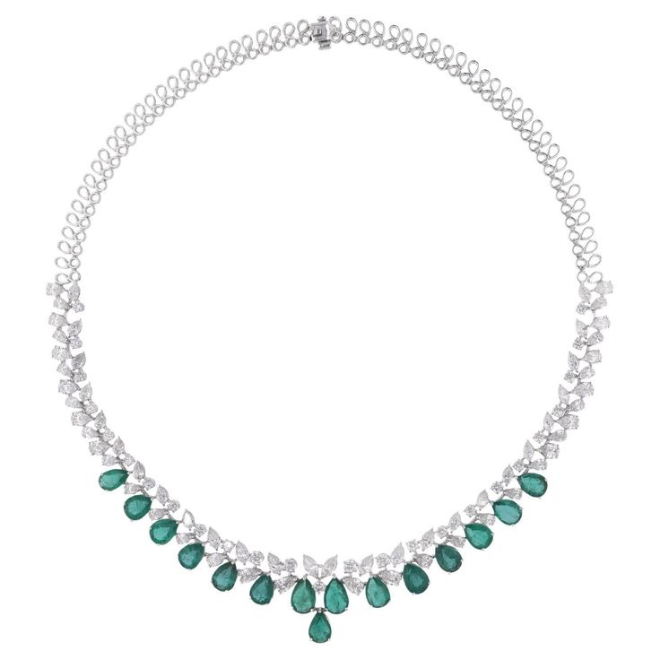 Elevate your style with the luxurious charm of this Pear Zambian Emerald Gemstone Choker Necklace, accented by shimmering Diamonds and meticulously crafted in 14k White Gold. This exquisite piece of jewelry is a celebration of sophistication and natural beauty, designed to grace your neckline with unparalleled elegance and allure. Item Code :- SEN-51270 (14k) Gross Wt. :- 29.77 gm 14k Solid White Gold Wt. :- 24.60 gm Natural Diamond Wt. :- 12.39 Ct. ( AVERAGE DIAMOND CLARITY SI1-SI2 & COLOR H-I Gemstone Choker Necklace, Gemstone Choker, Necklace Diamond, Colored Stone, Zambian Emerald, Emerald Necklace, Large Gift, Antique Necklace, White Gold Jewelry