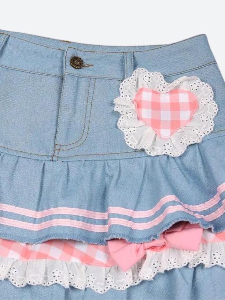 This denim mini skirt captures the kawaii aesthetic with its plaid layers, ruffle design, and heart-shaped plaid detail. Adorned with ribbons, lace, and bows, along with belt loops, it's a playful and stylish piece for casual or streetwear outfits. Kawaii aesthetic Plaid layer details Ruffle design Heart shaped plaid detail at front Ribbon & lace details Bows on skirt Belt loop details A-line Button & zip fastening Double pockets at front Cotton, polyester