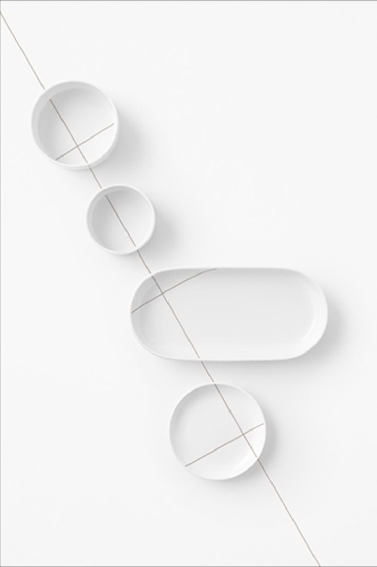 three white oval objects are hanging on a string