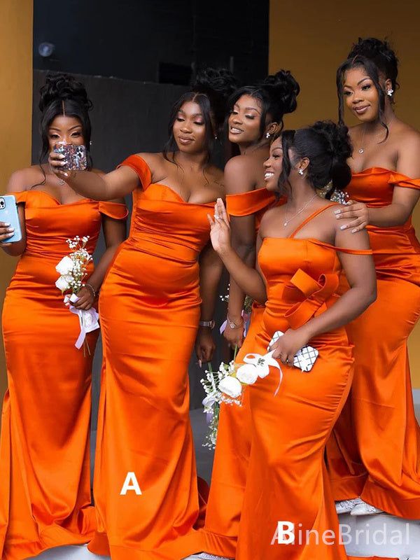 the bridesmaids are all dressed in bright orange dresses and one is holding her phone