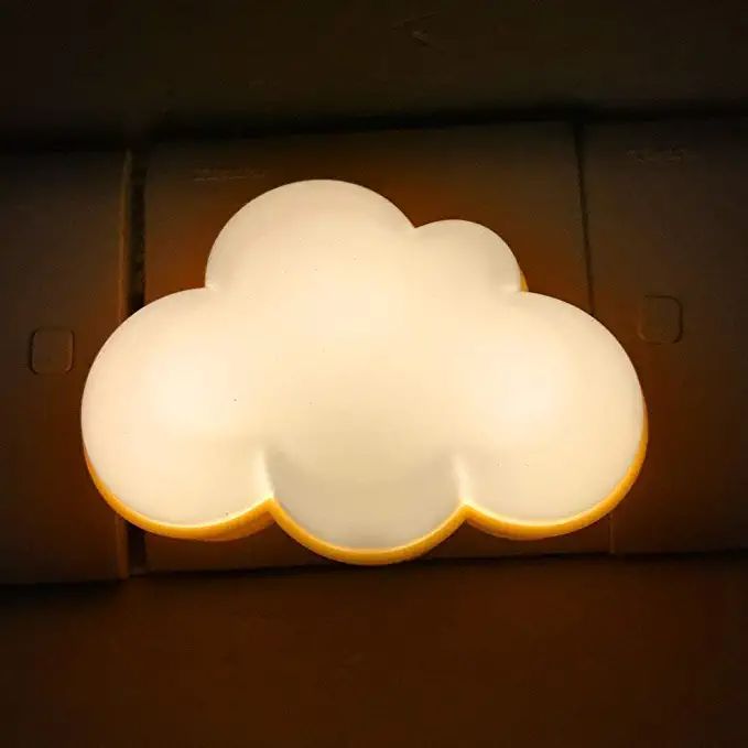 a white cloud shaped light on the side of a wall