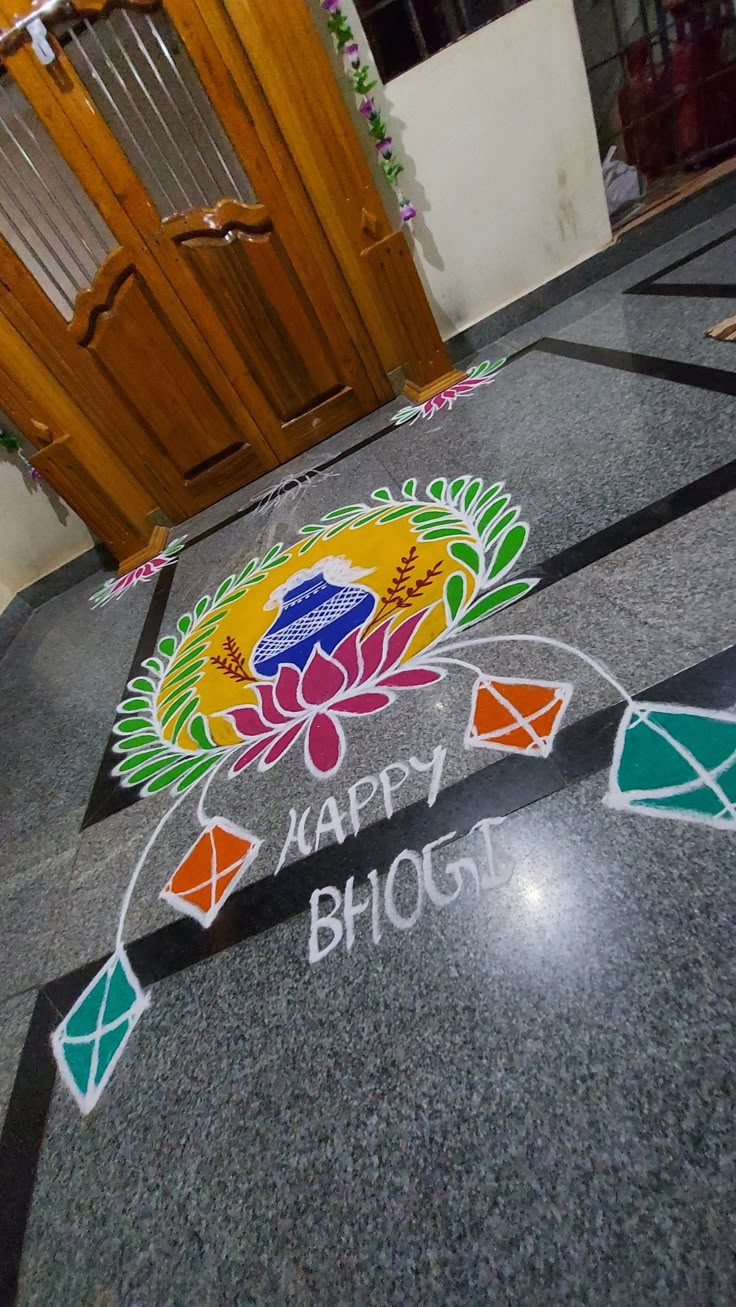 the name happy bhoj written on the floor in front of an entrance door