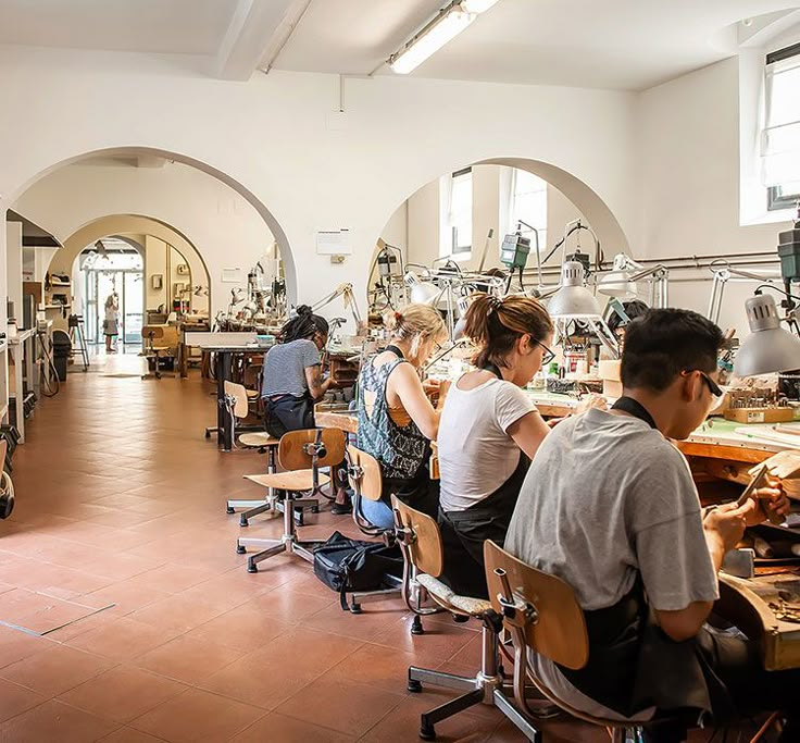 people sitting at desks in a large room