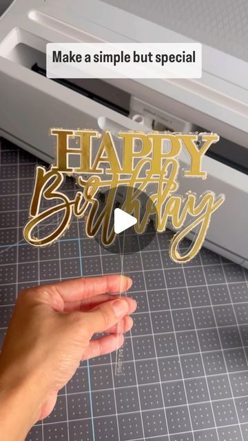 someone is making a happy birthday card with the word happy birthday in gold foil on it