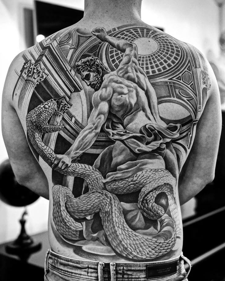 the back of a man with tattoos on his body