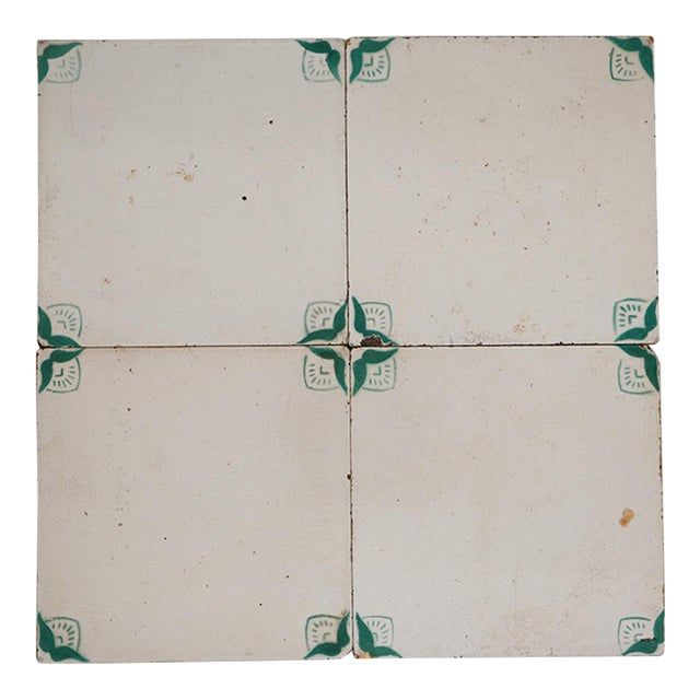 four square tiles with green and white designs on them