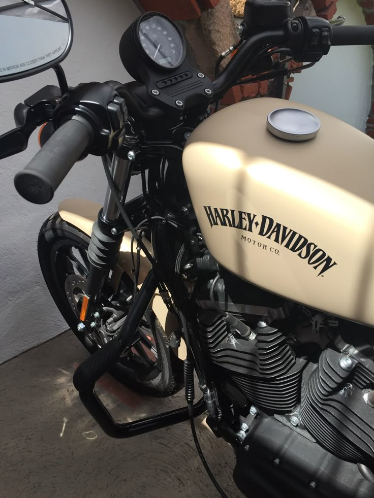 a motorcycle parked next to a building with a clock on it