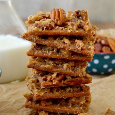 a stack of cookies sitting on top of a table next to a glass of milk