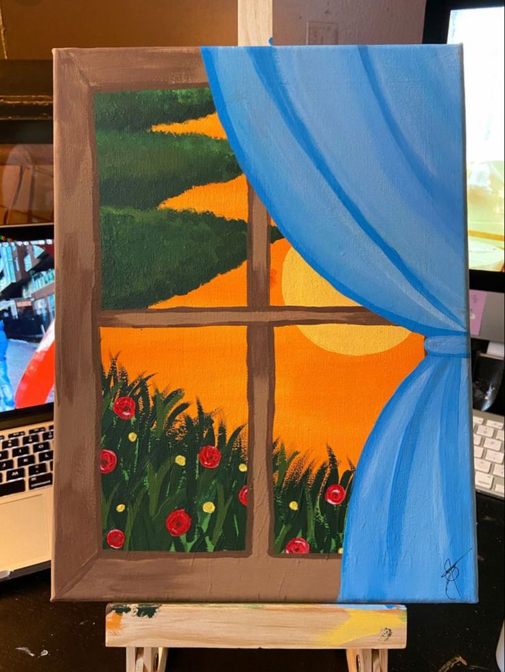 an easel with a painting on it in front of a laptop computer