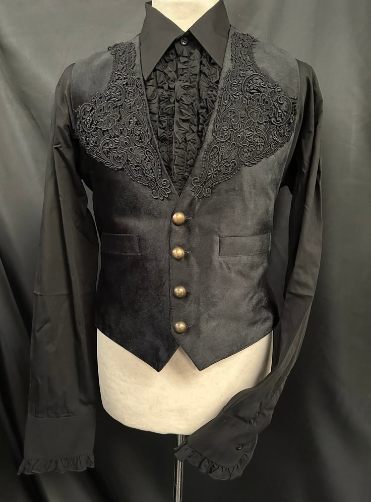 This is a stunning black velvet waist coat.It is fully lined with pockets. It has embroidery detail to the front with enriched detail. It has pockets and adjustable back and has rustic buttons.  It comes with black shirt with frill detail to the front. Well presented  high quality . Chest measurement is ML approx 40/42 . Vest  Length front approx 24" *Please note and marks or creases in the velvet is the characteristics and nature of the material is is NoT a defect. Makes a stunning steampunk ge Black Gothic Vest For Fall, Gothic Vest With Buttons For Fall, Gothic Button Vest For Fall, Black Gothic Velvet Outerwear, Black Velvet Gothic Outerwear, Gothic Fitted Velvet Outerwear, Fitted Gothic Velvet Outerwear, Fitted Gothic Vest For Halloween, Black Gothic Vest For Winter