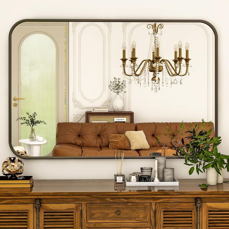 a living room filled with furniture and a large mirror over the top of a dresser