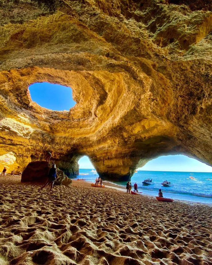 the inside of a cave with sand and water