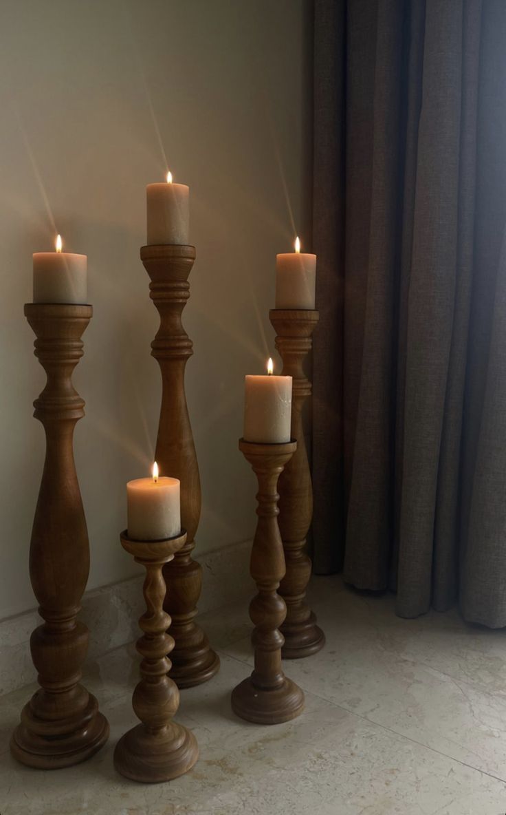 three wooden candles are lined up next to each other