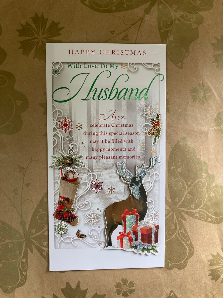 a christmas card with an image of a deer and presents on it's side